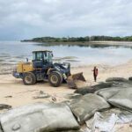 Alat berat diterjunkan untuk membersihkan geobag yang rusak di Pantai Selagan Nusa Dua.